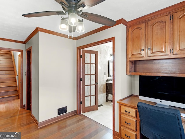 home office with ceiling fan, light hardwood / wood-style floors, ornamental molding, and french doors