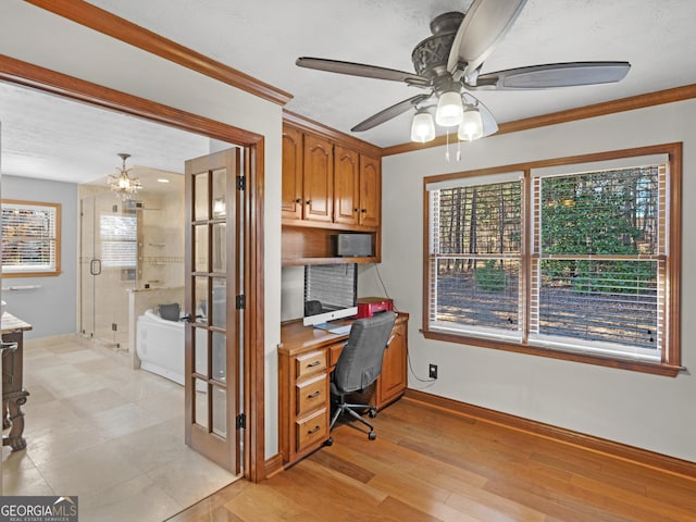 home office with light wood-type flooring, ceiling fan with notable chandelier, and ornamental molding