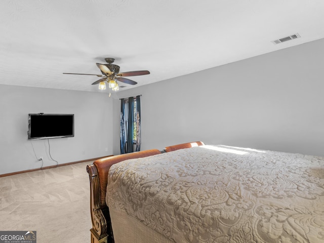 bedroom with ceiling fan and light carpet