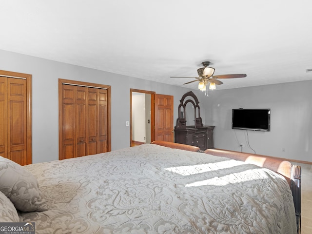 bedroom with multiple closets and ceiling fan