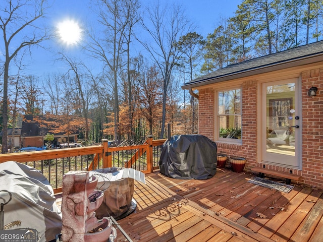 wooden deck with a grill