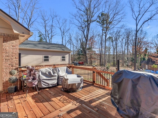 wooden deck featuring a grill