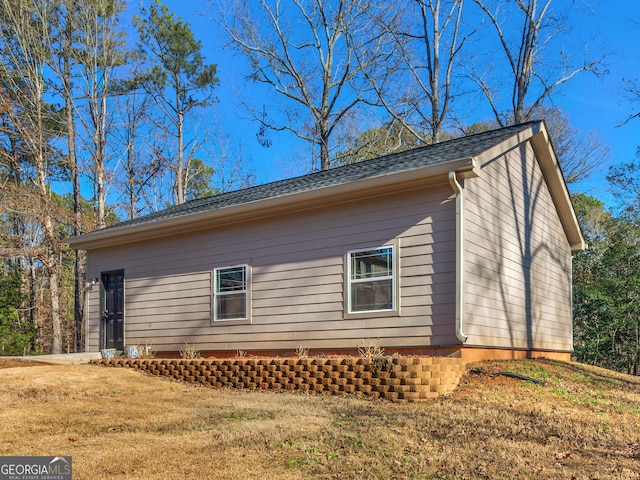 view of side of property with a yard