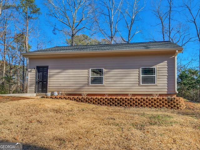 view of side of home with a lawn