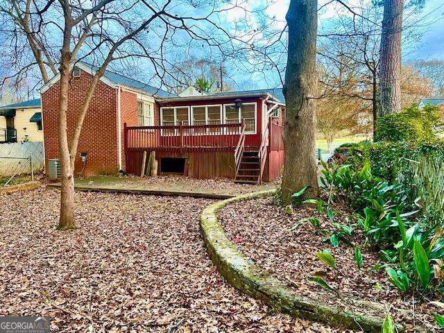 back of house featuring a wooden deck