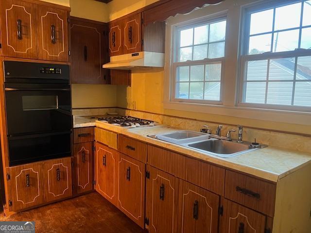 kitchen featuring sink, stainless steel gas cooktop, and black double oven