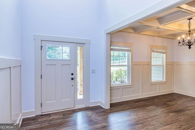 entrance foyer with beamed ceiling, an inviting chandelier, dark wood-type flooring, and coffered ceiling