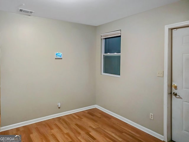 unfurnished room with wood-type flooring