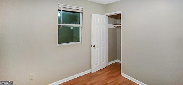 hallway with wood-type flooring