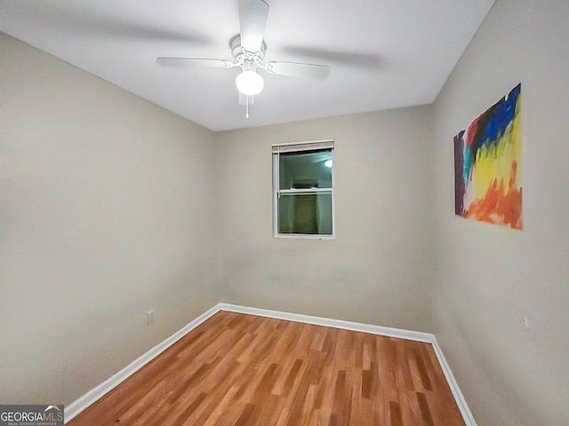 spare room with ceiling fan and wood-type flooring