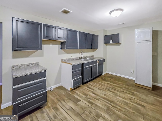 kitchen featuring dark hardwood / wood-style flooring and sink