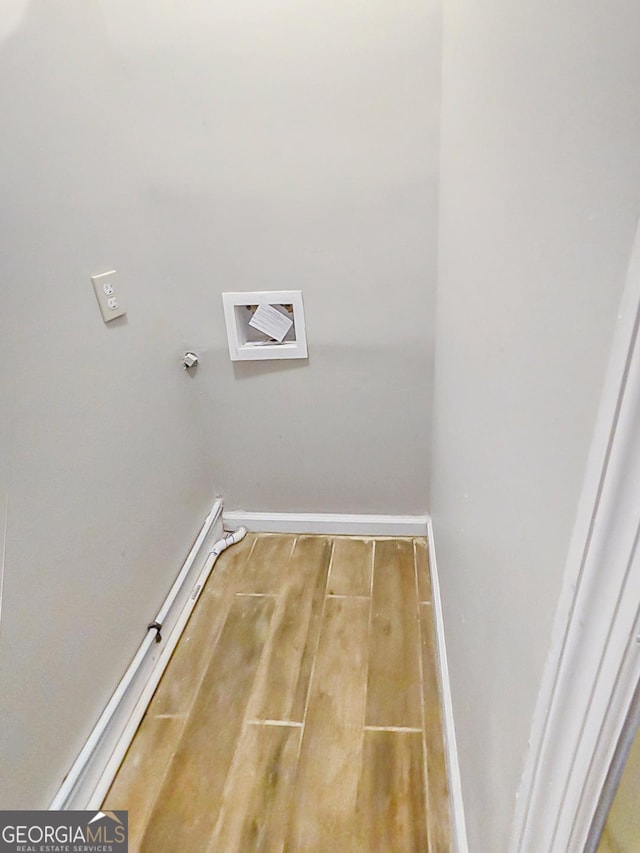 laundry room featuring hardwood / wood-style flooring and electric dryer hookup