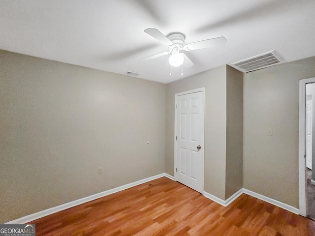 unfurnished bedroom featuring hardwood / wood-style flooring and ceiling fan