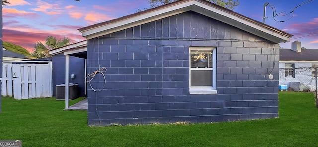 property exterior at dusk with a yard