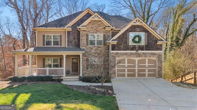 craftsman inspired home featuring a front yard, a porch, and a garage