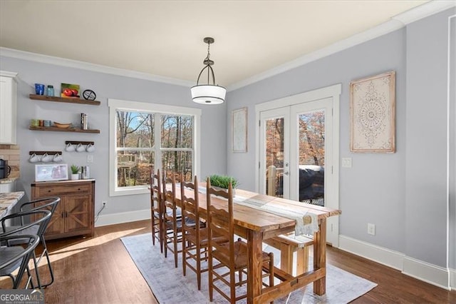 dining area featuring dark wood-type flooring and ornamental molding