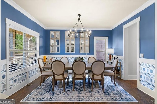 dining space featuring a notable chandelier, crown molding, and dark wood-type flooring