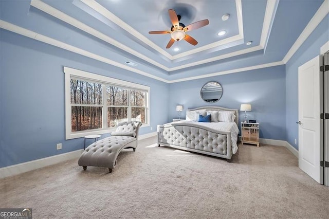 bedroom featuring a raised ceiling, ceiling fan, carpet, and ornamental molding