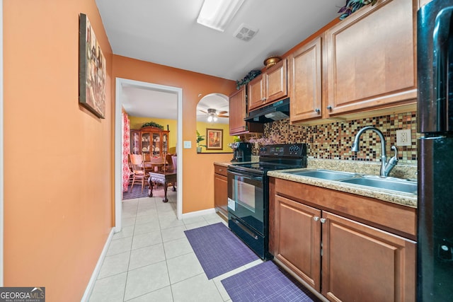 kitchen featuring decorative backsplash, ceiling fan, sink, black appliances, and light tile patterned floors