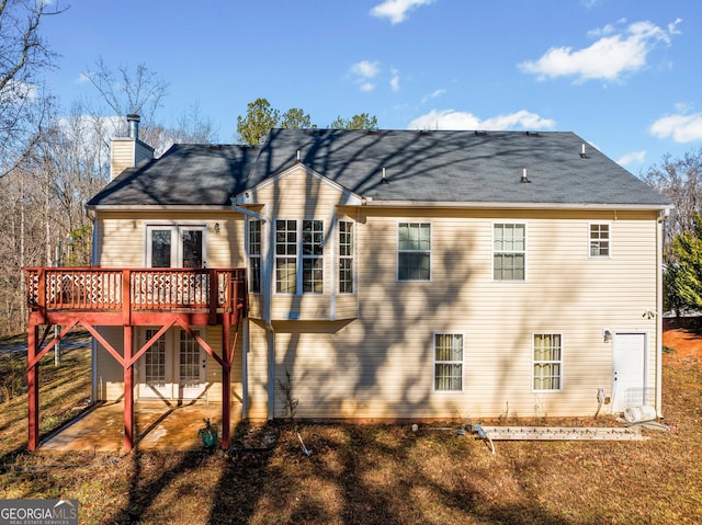 back of property featuring a wooden deck