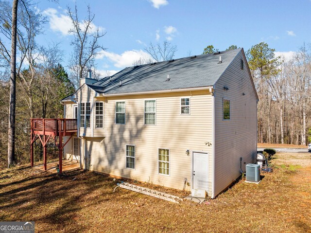 back of property with central air condition unit and a wooden deck