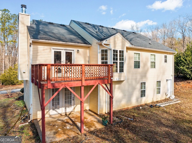 rear view of house featuring french doors and a deck