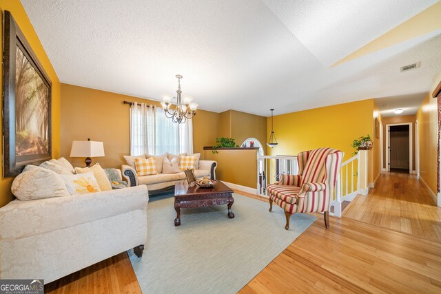 living room featuring hardwood / wood-style floors and a notable chandelier