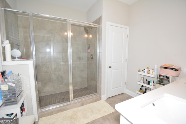 bathroom with vanity, tile patterned floors, and a shower with shower door