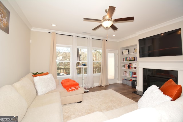 living room with hardwood / wood-style floors, ceiling fan, and ornamental molding