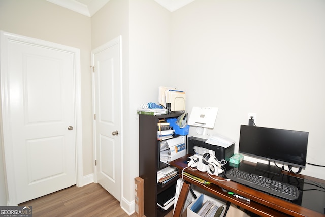 office space with wood-type flooring and crown molding