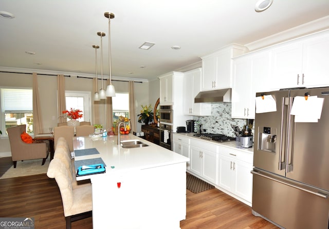 kitchen with white cabinets, pendant lighting, stainless steel appliances, and sink