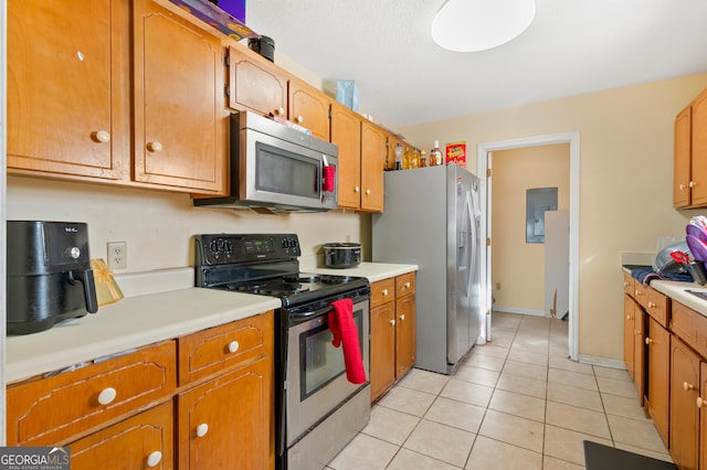 kitchen featuring appliances with stainless steel finishes and light tile patterned flooring