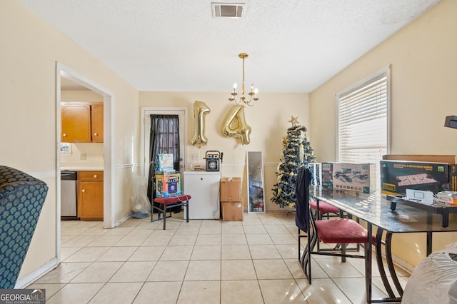 dining area featuring light tile patterned floors, a textured ceiling, and a notable chandelier