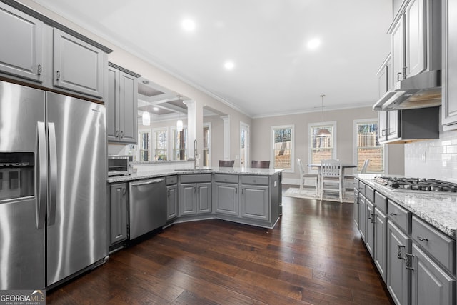 kitchen with sink, decorative light fixtures, gray cabinets, decorative backsplash, and appliances with stainless steel finishes