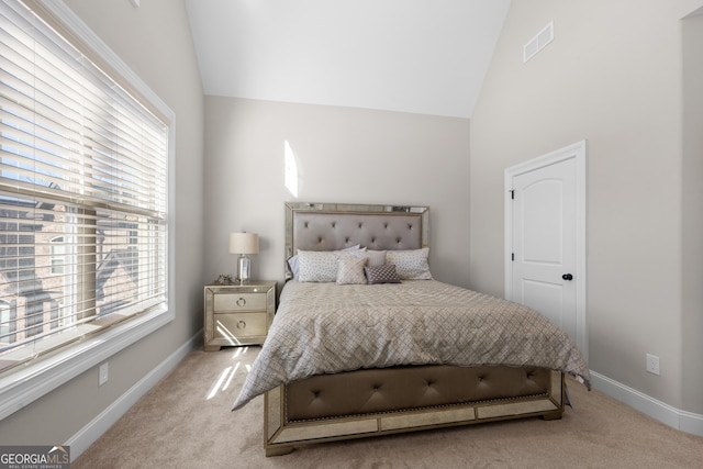 carpeted bedroom with vaulted ceiling