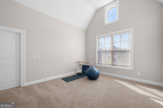 workout room featuring carpet flooring and vaulted ceiling