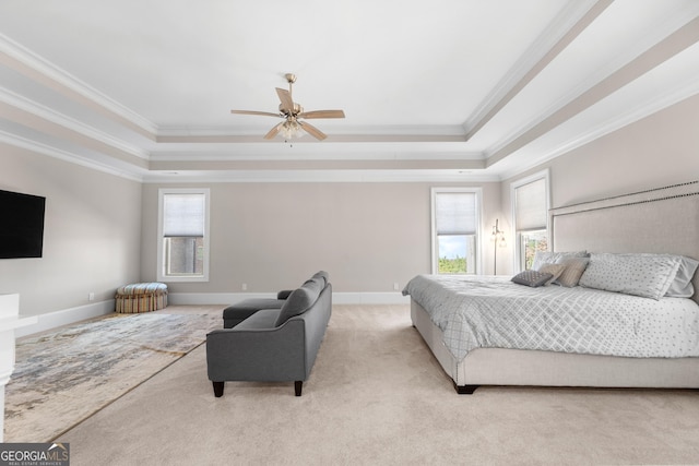 bedroom featuring ceiling fan, crown molding, and a tray ceiling