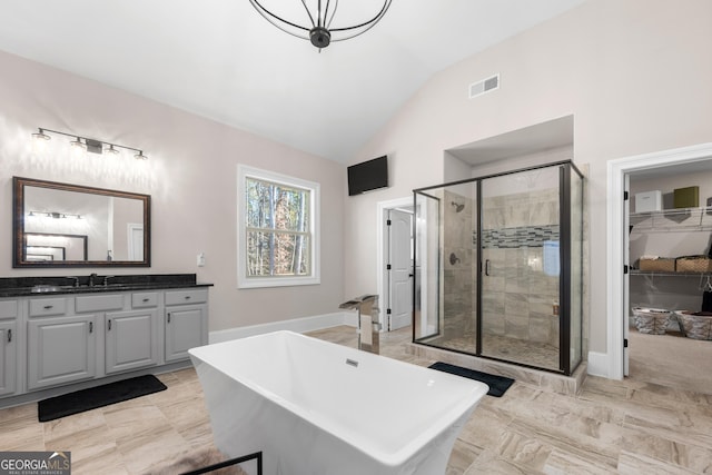 bathroom with vanity, separate shower and tub, and lofted ceiling