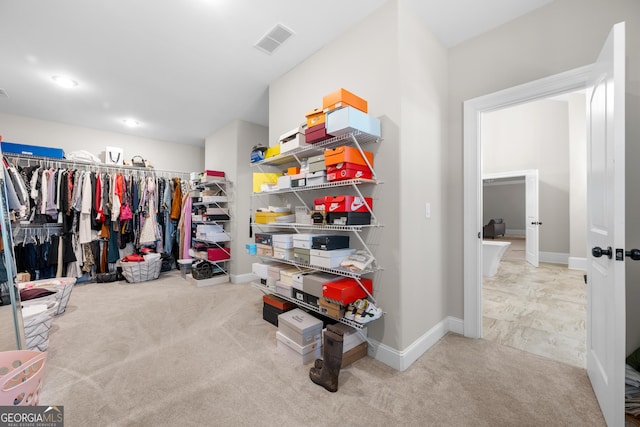 walk in closet with carpet floors