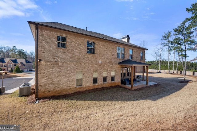 rear view of house featuring a patio area and central AC