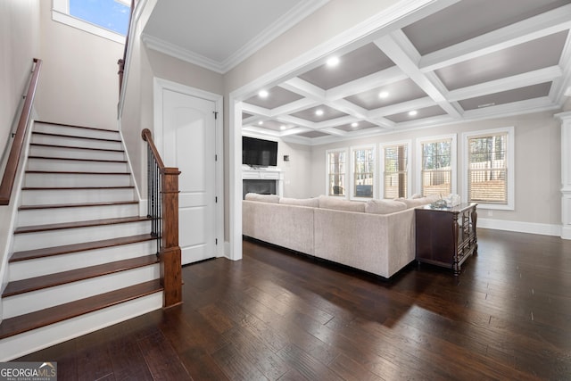 living room featuring beamed ceiling, ornamental molding, dark wood-type flooring, and coffered ceiling