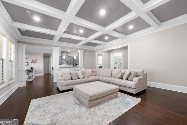 living room featuring ornate columns, ornamental molding, coffered ceiling, dark wood-type flooring, and beamed ceiling