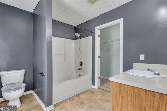 bathroom featuring baseboards, toilet, shower / washtub combination, and vanity