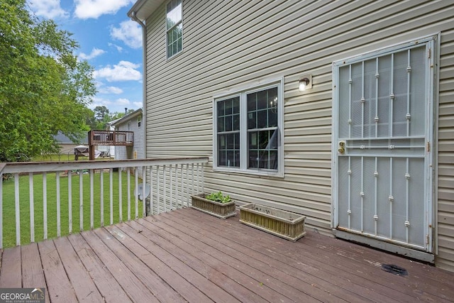 wooden terrace with a yard