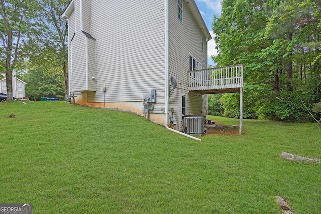 view of home's exterior featuring a wooden deck, a lawn, and cooling unit