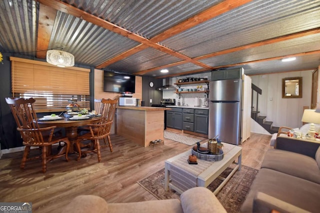 living room with light hardwood / wood-style flooring and sink