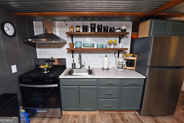 kitchen with wall chimney range hood, sink, light hardwood / wood-style flooring, decorative backsplash, and appliances with stainless steel finishes