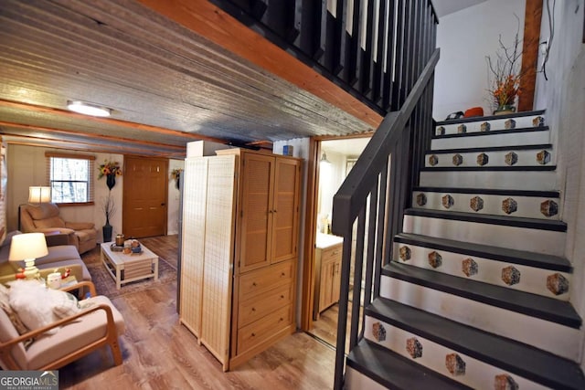 staircase with hardwood / wood-style flooring and wooden ceiling