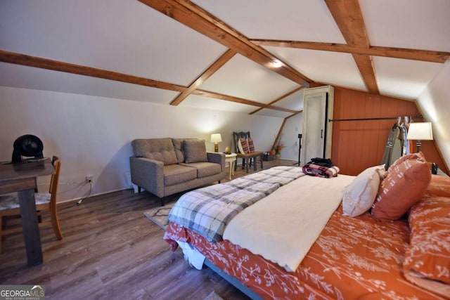 bedroom featuring hardwood / wood-style floors and lofted ceiling with beams