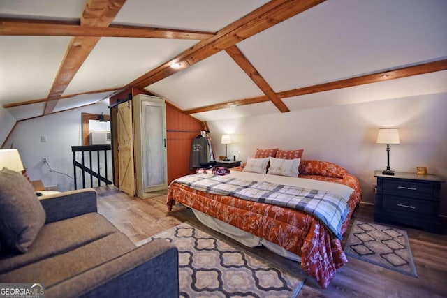 bedroom featuring lofted ceiling with beams and light wood-type flooring